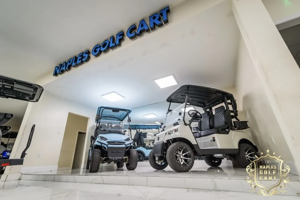 Inside the Naples Golf Cart showroom with the lit Naples Golf Cart sign