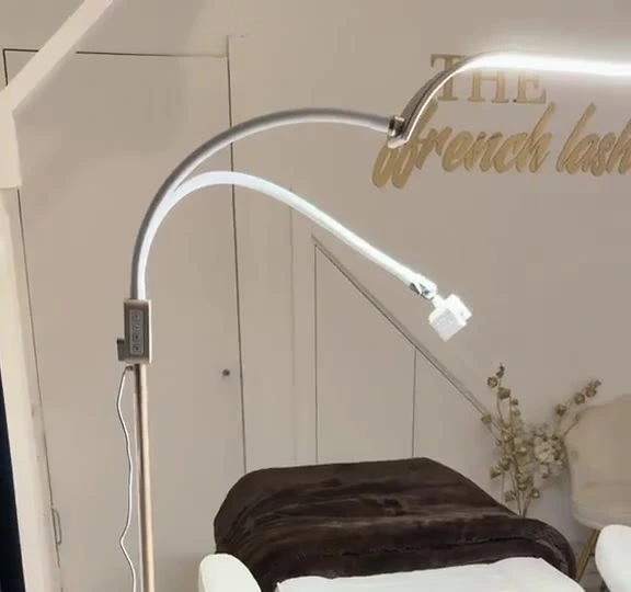 The curved lash lamp over the treatment bed, with the gold Ffrench Lash sign on the wall
