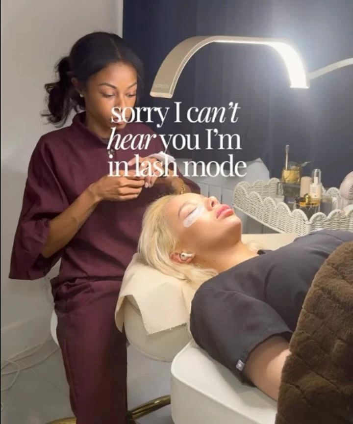 Jordy applying lash extensions to a client. Opens Instagram.