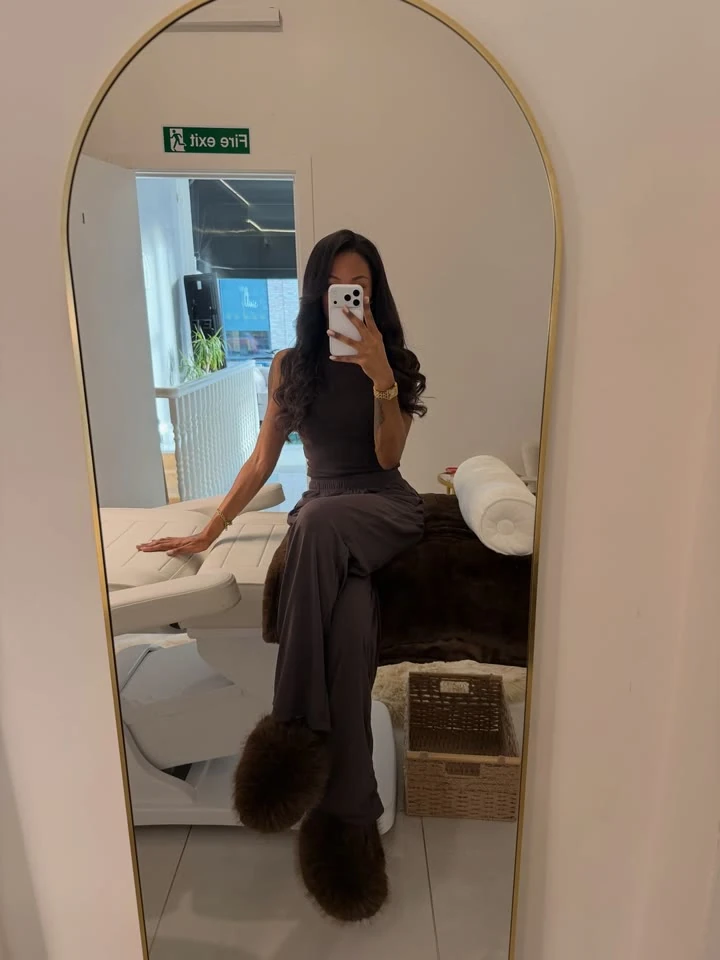 Jordy in the Fulham studio beside a treatment bed. Opens Instagram.