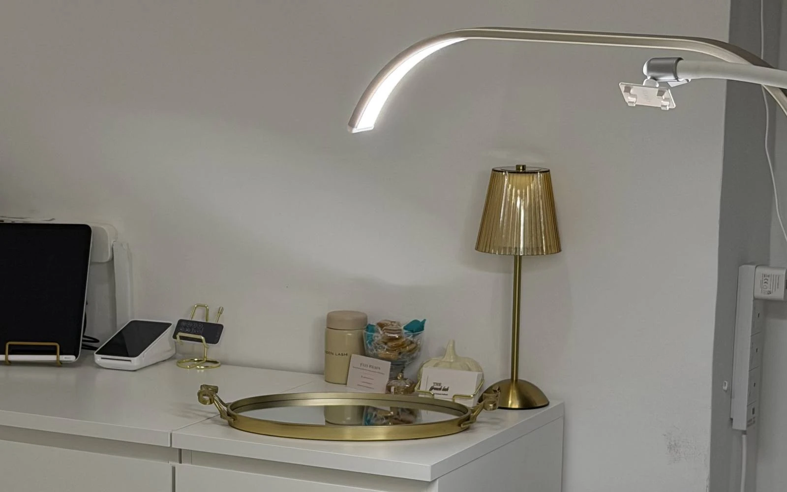 The treatment bed, gold lamp and lash lamp in the private Fulham studio