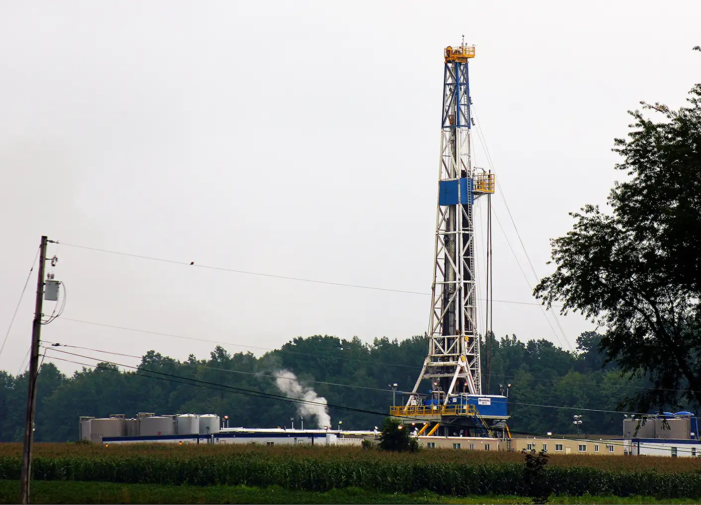 Drilling rig and tanks on a well pad