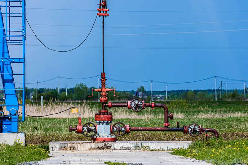 Wellhead piping on a grassy location