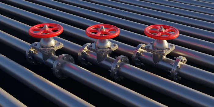 Row of red gate valves on steel pipelines
