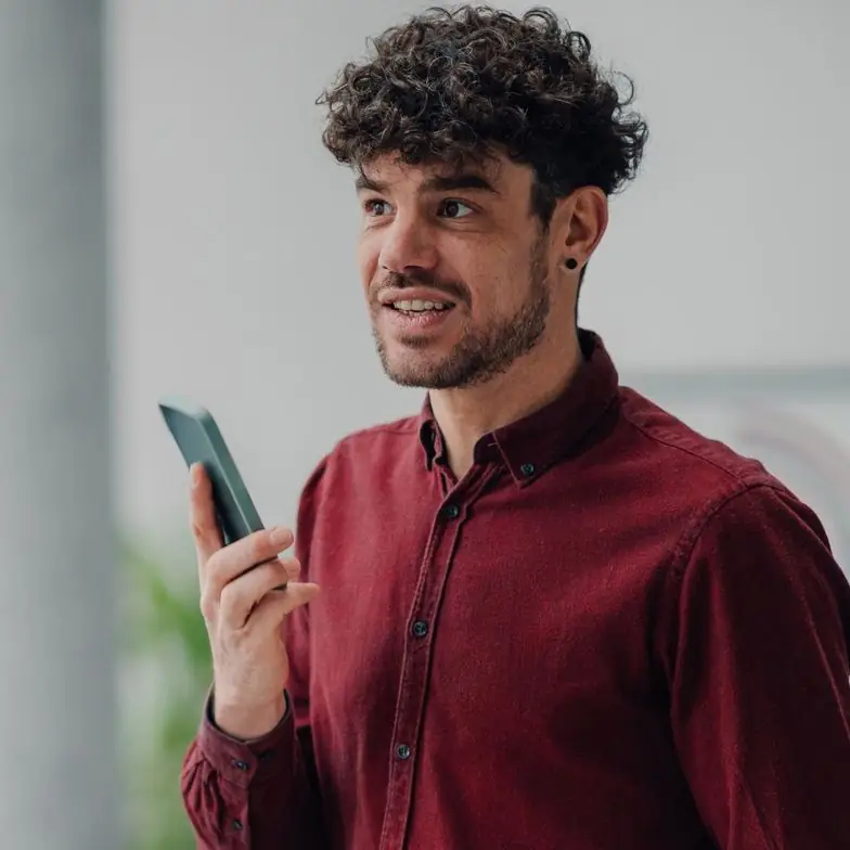 Employee on a phone call holding a clipboard in the office
