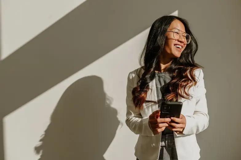 A smiling businesswoman checking her smartphone