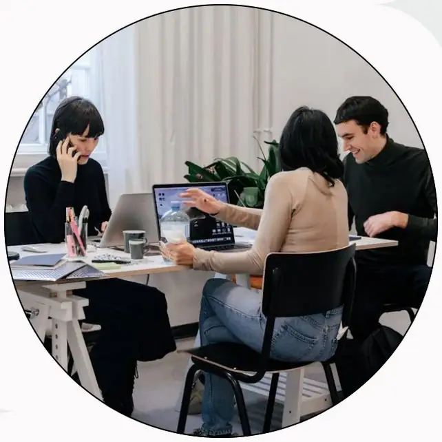 Startup team of four working together at a white table