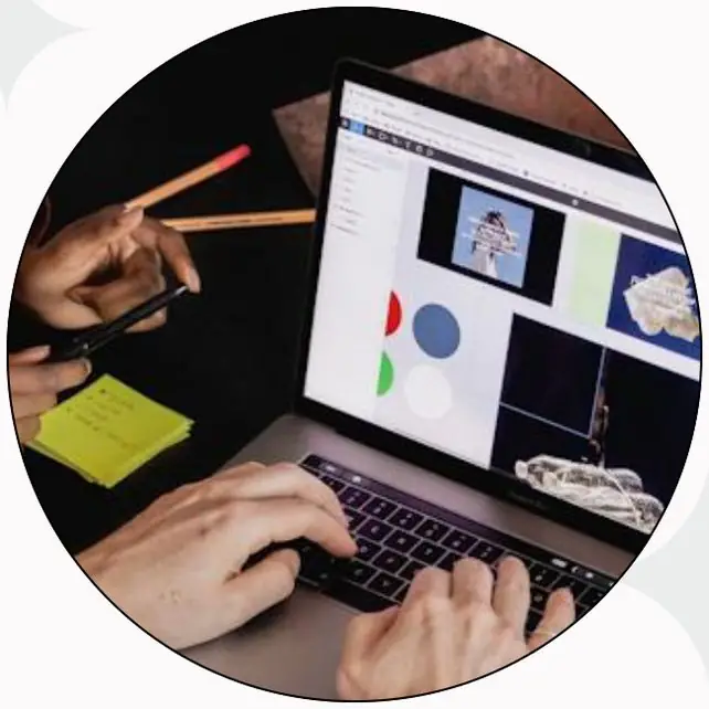 Hands on a laptop showing a design board