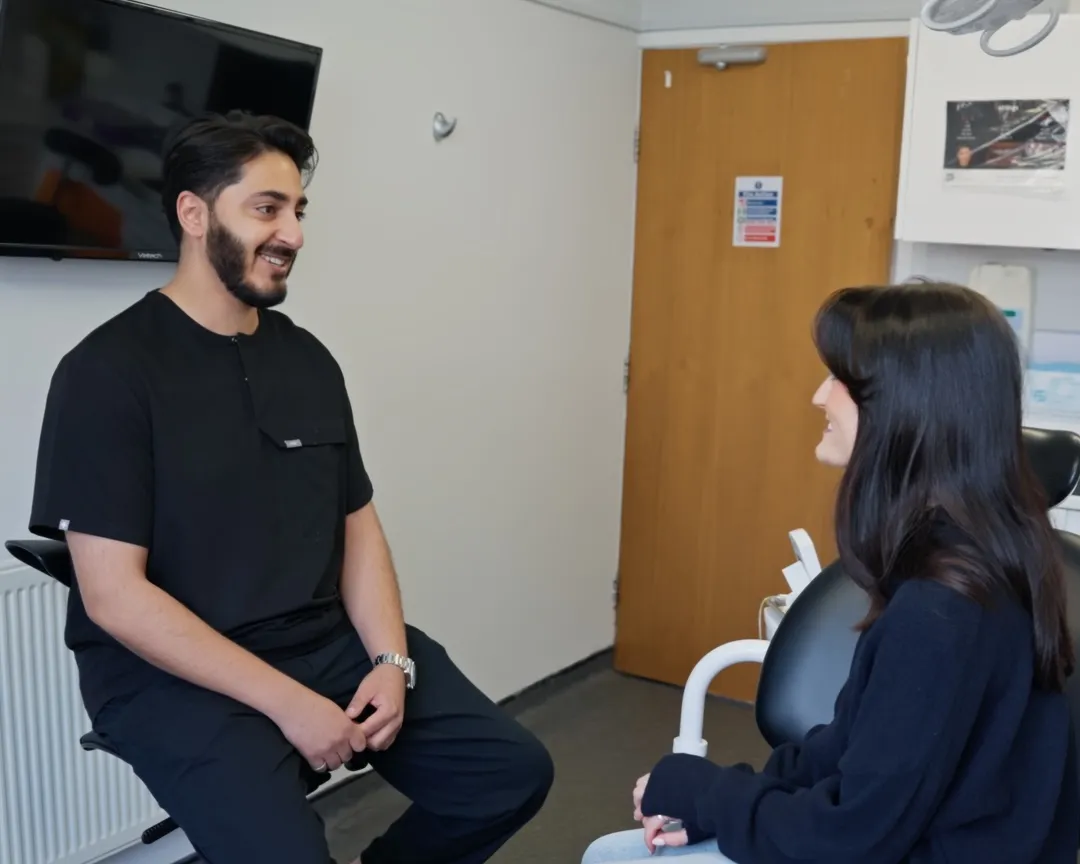 Dr Hamza Mirza talking a patient through their options at Sale Dental Spa