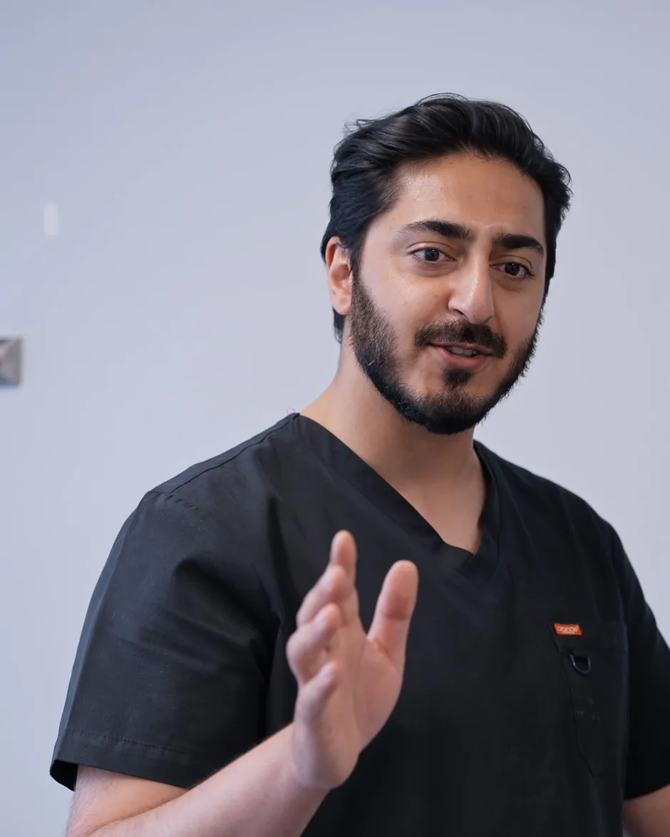 Dr Hamza Mirza explaining a treatment option in a consultation room