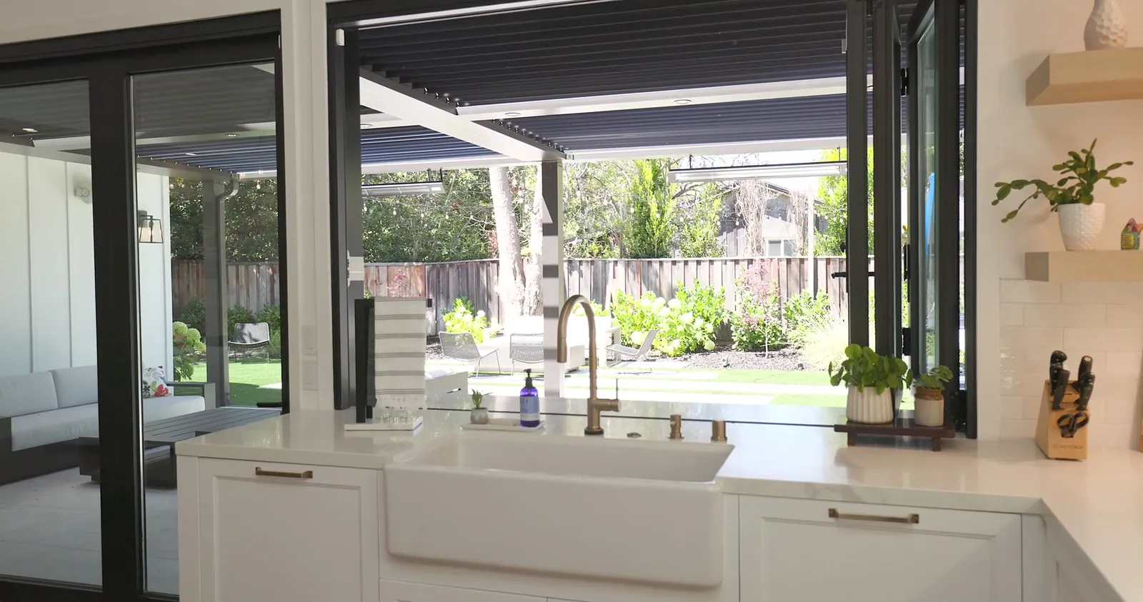 Golden Way kitchen opening onto a covered patio and garden