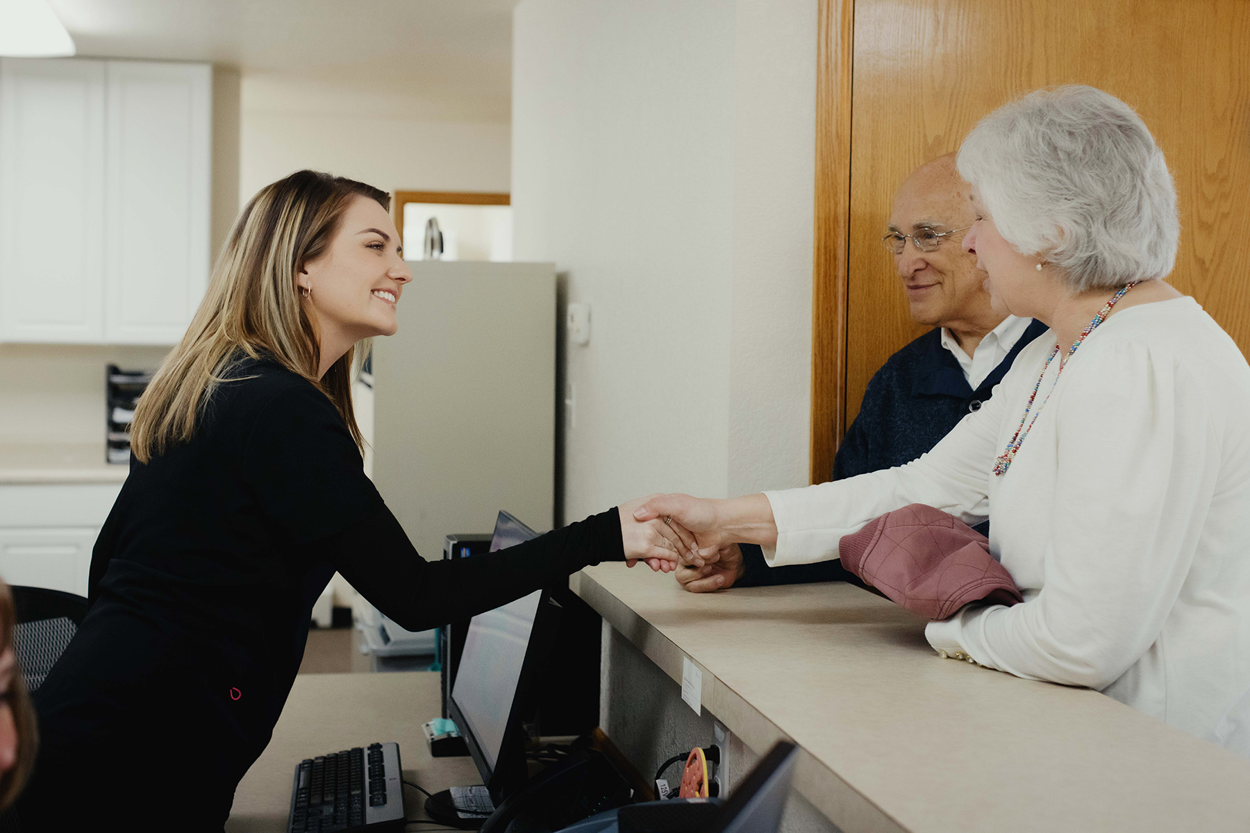 Receptionist at Pheasant Ridge Dental welcoming patients
