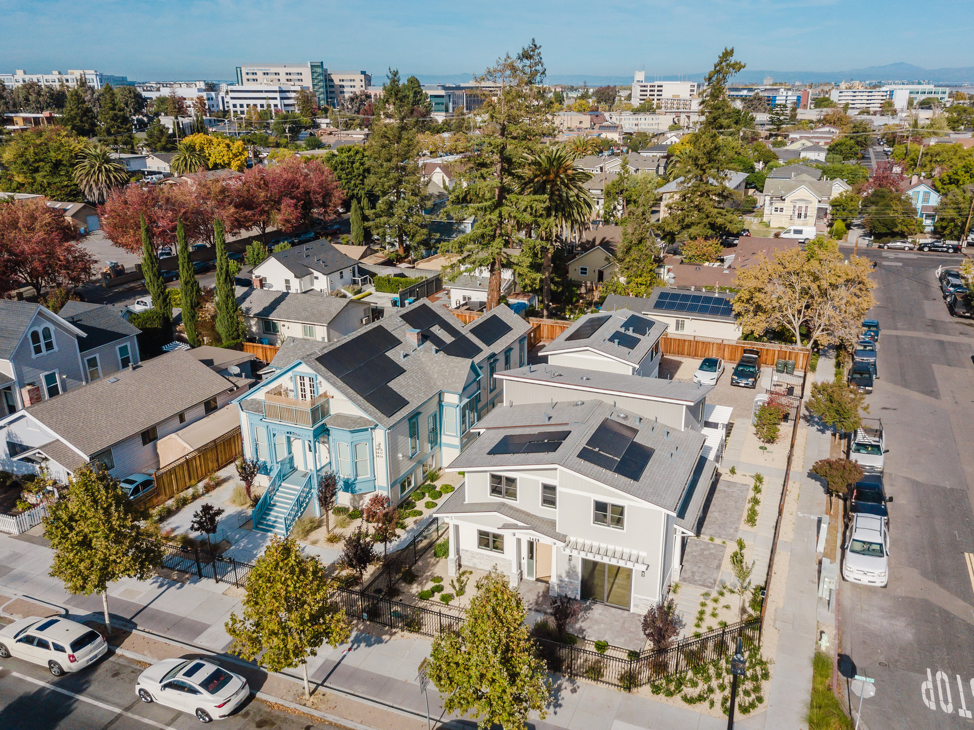 Aerial view of new homes in a mature residential neighborhood.