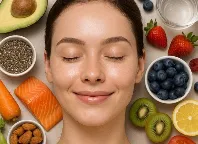 Woman with healthy skin surrounded by skin-friendly foods like avocado, salmon and berries