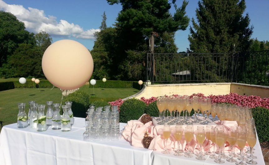 Outdoor welcome drink station with champagne glasses at a wedding