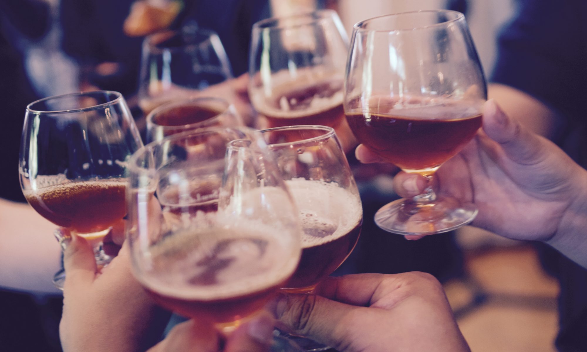 Friends toasting with wine and beer at a holiday party