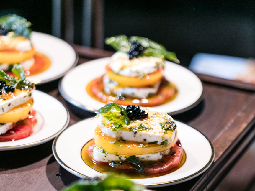 Stacked layered appetizers plated for a catered corporate event