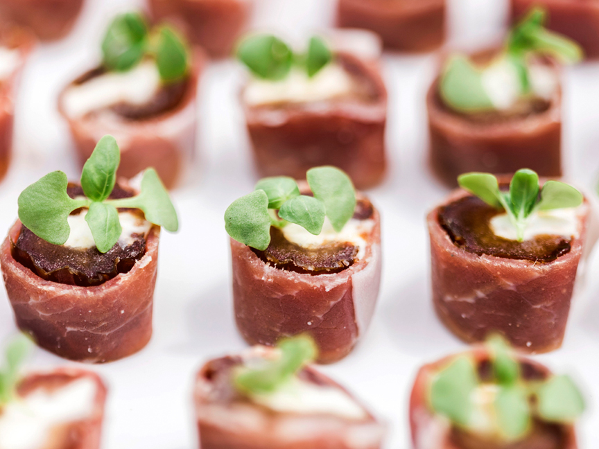 Rolled beef hors d'oeuvres topped with microgreens