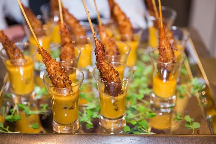 Skewered hors d'oeuvres served in shot glasses with sauce