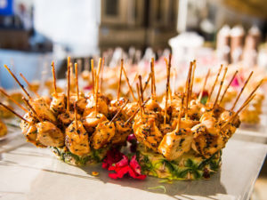 Chicken skewers arranged in a pineapple display