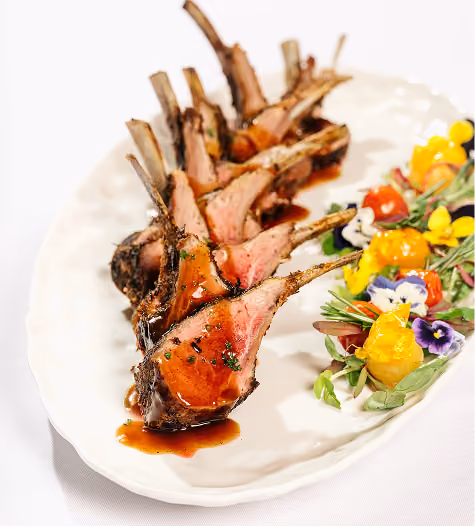 Rack of lamb plated with edible flowers