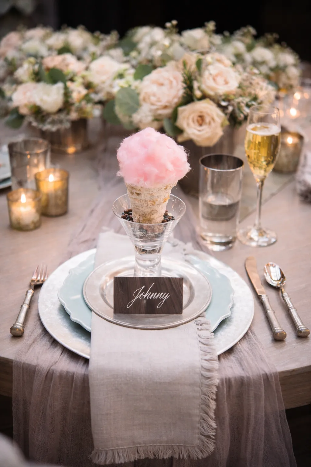 Wedding place setting with pink cotton candy and a handwritten name card