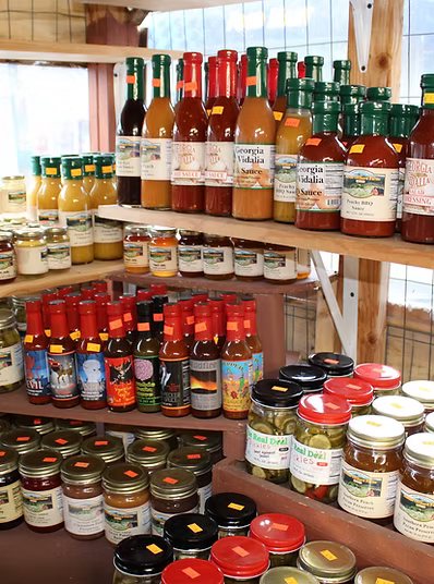 Shelf of Prewett’s own-label peach cider, pickles, salsas and sauces