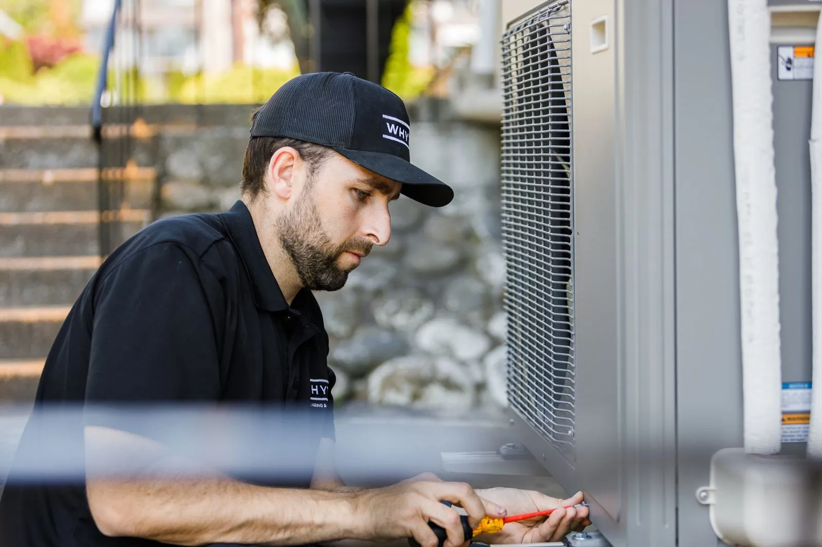 Whyte technician repairing an outdoor HVAC unit