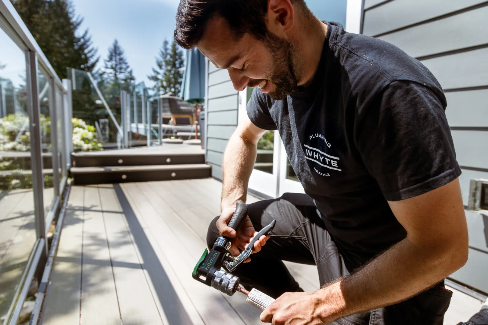 Whyte plumber working on a deck in Vancouver