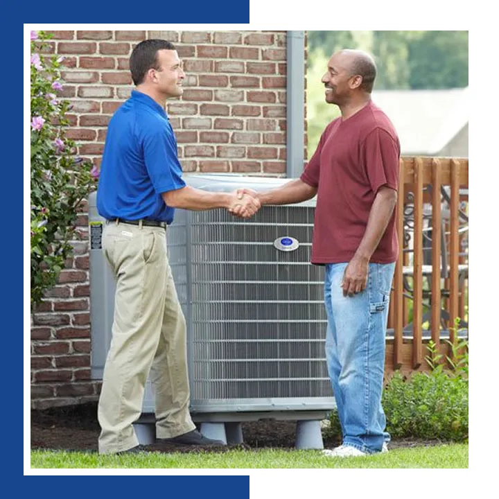 E.A.C. technician shaking hands with a homeowner beside a new Carrier air conditioner