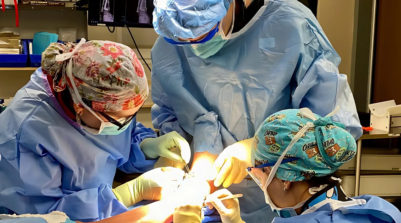Operating room: three surgeons at work