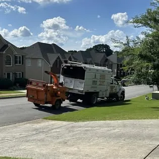 Sergeant Tree Services truck and chipper in a customer's driveway
