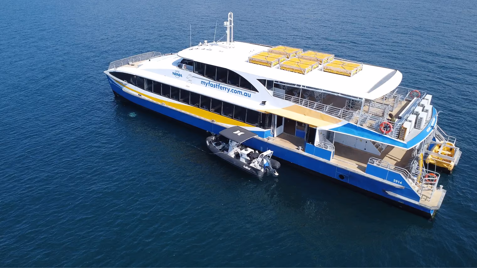 Aerial view of the NRMA Manly Fast Ferry catamaran on deep blue water