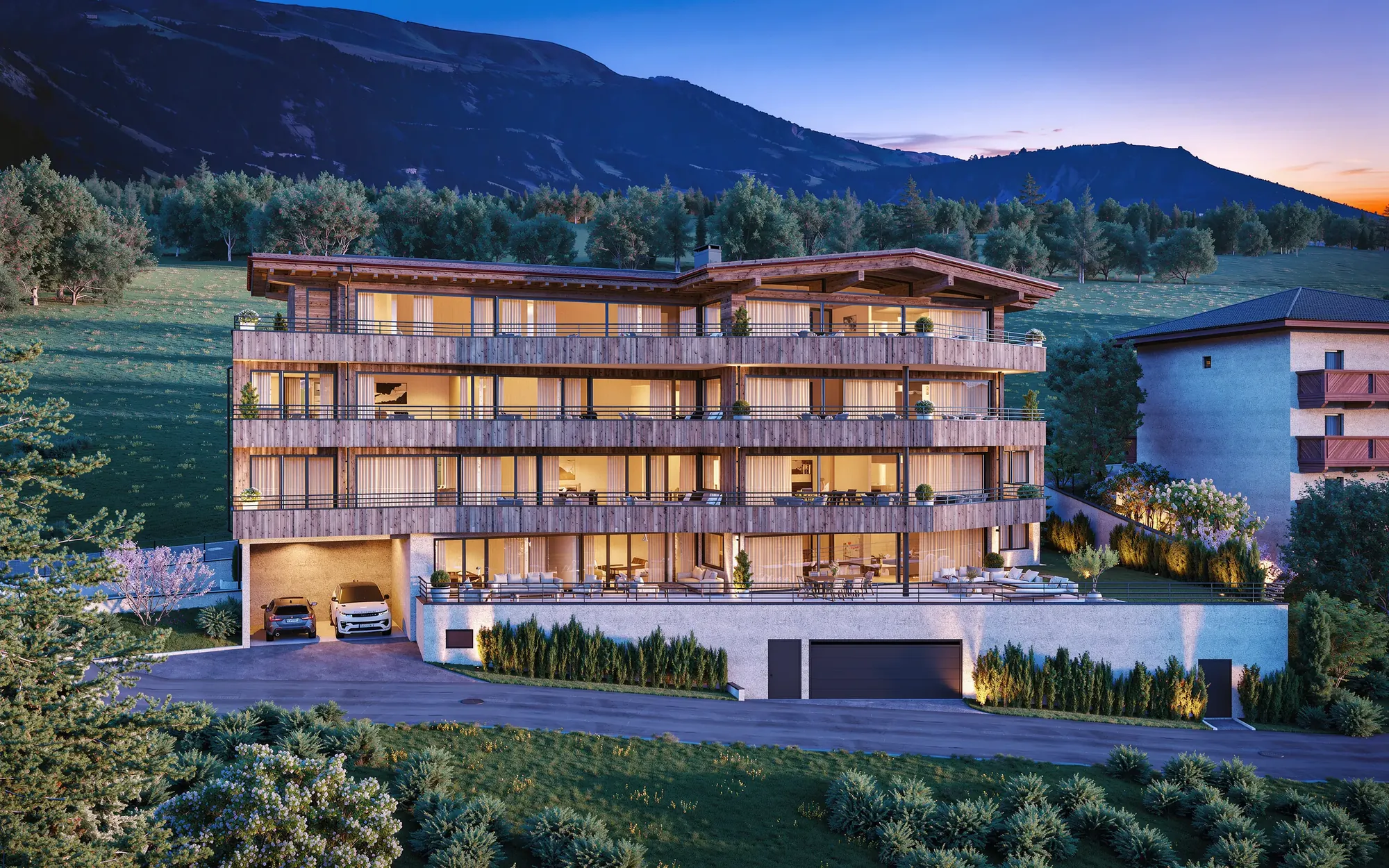 Wohnprojekt Zillertal am Abend mit beleuchteten Fenstern