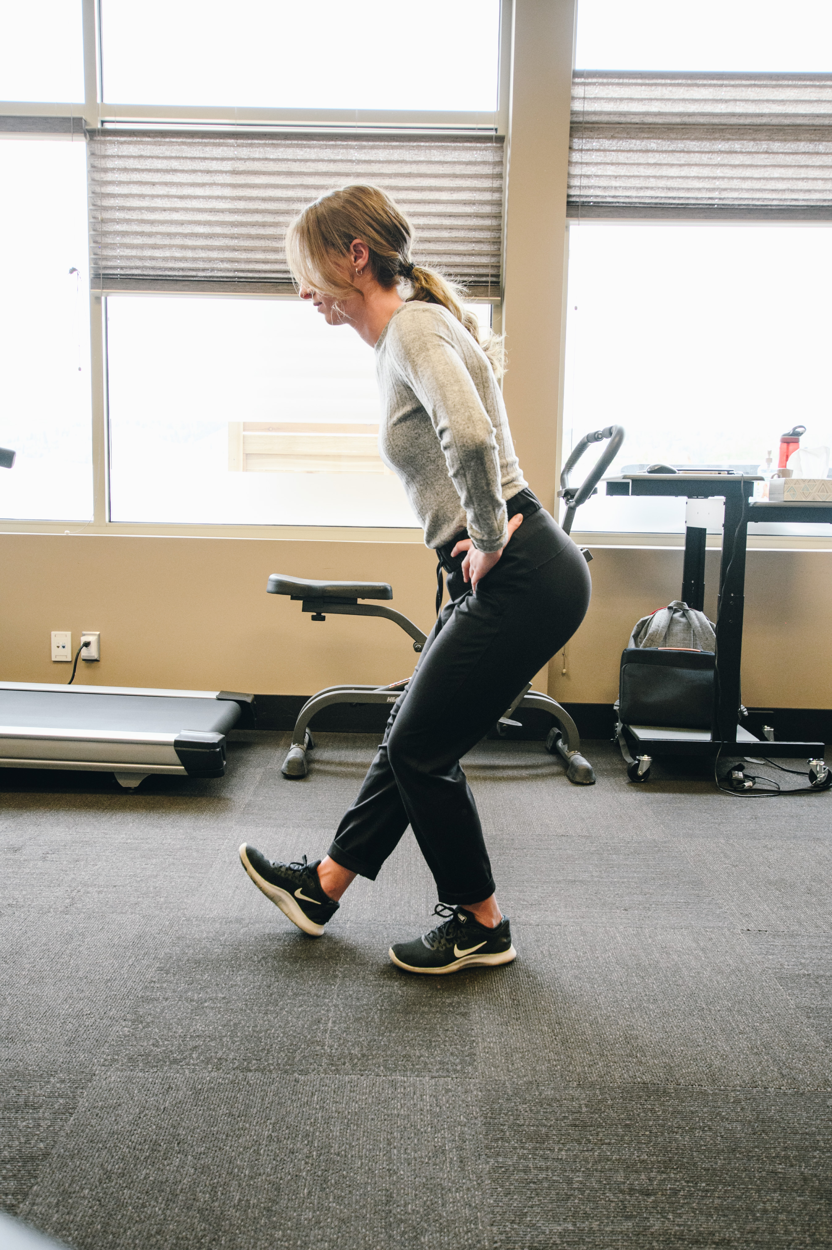 Client practising a lunge with a clinician as part of work conditioning