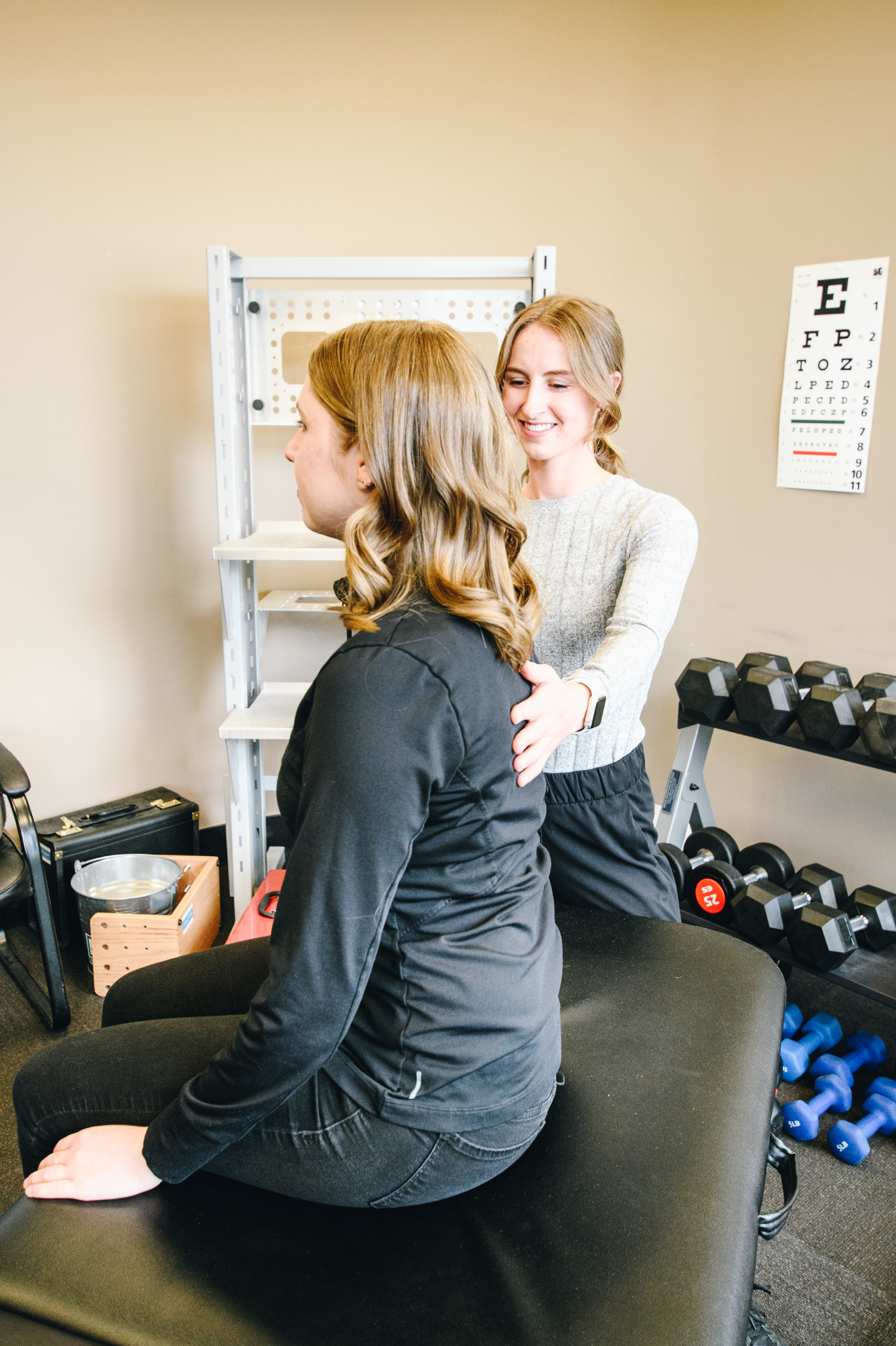 CTC occupational therapist assessing a client's posture in the clinic