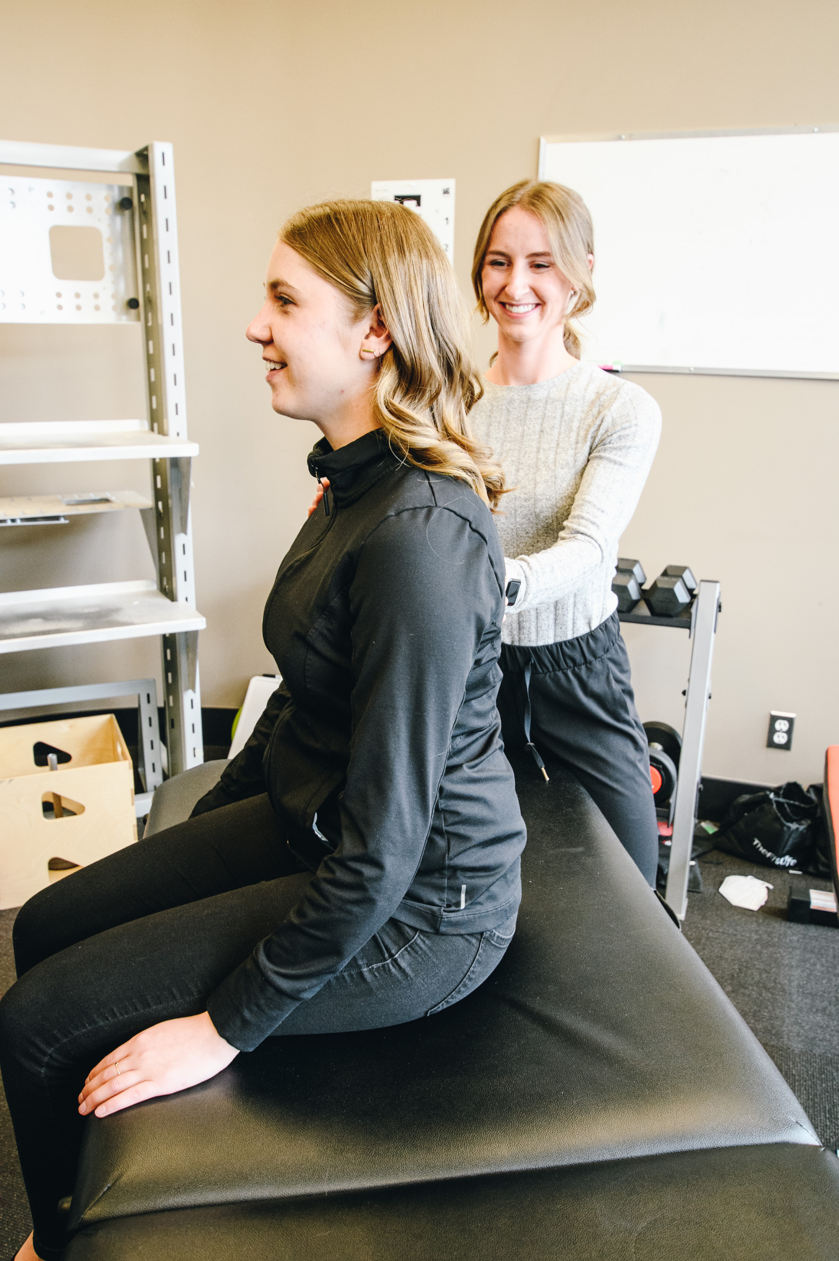 CTC occupational therapist and client smiling during a seated posture check