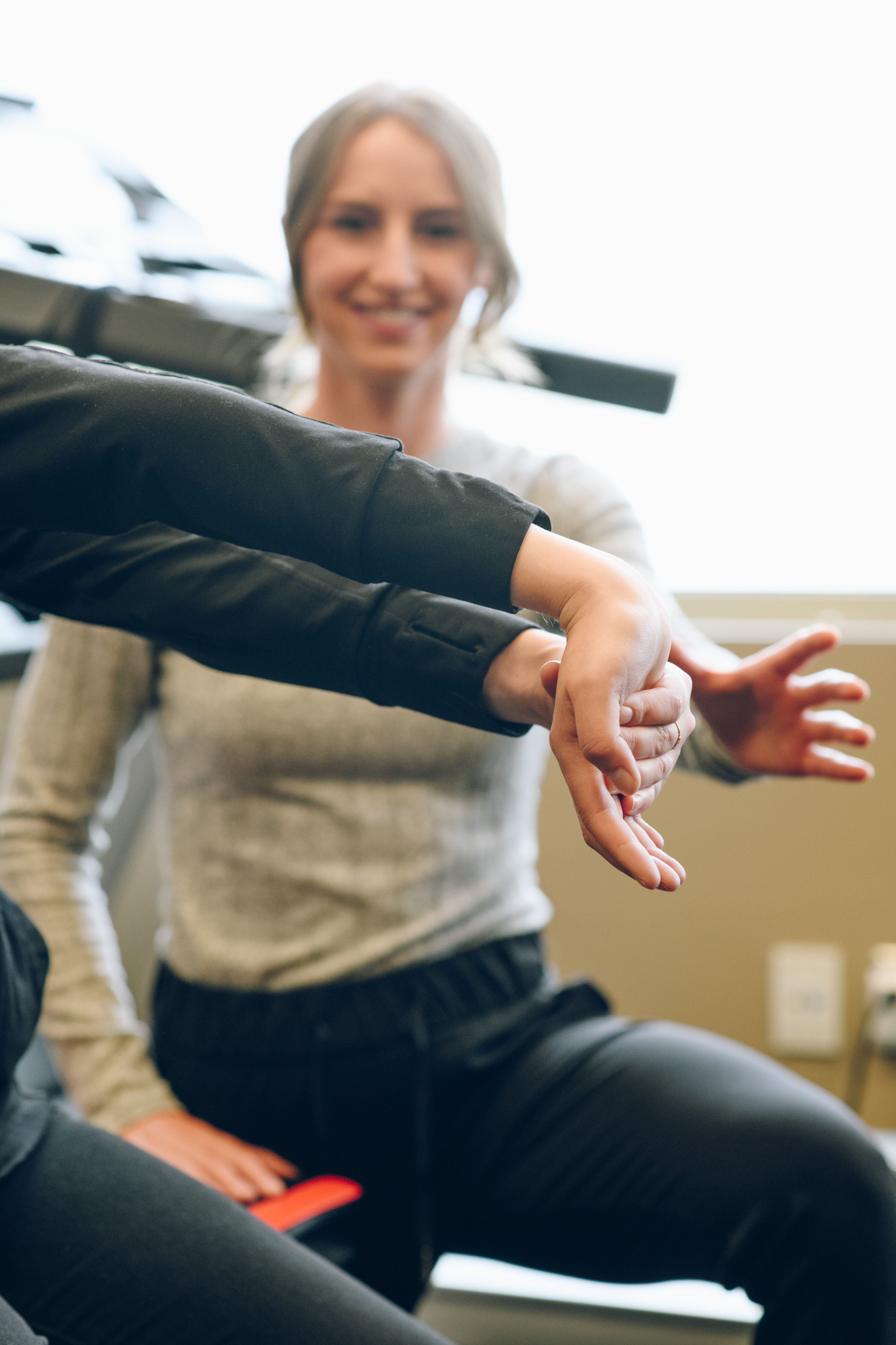 Occupational therapist measuring a client's arm and shoulder movement during an assessment