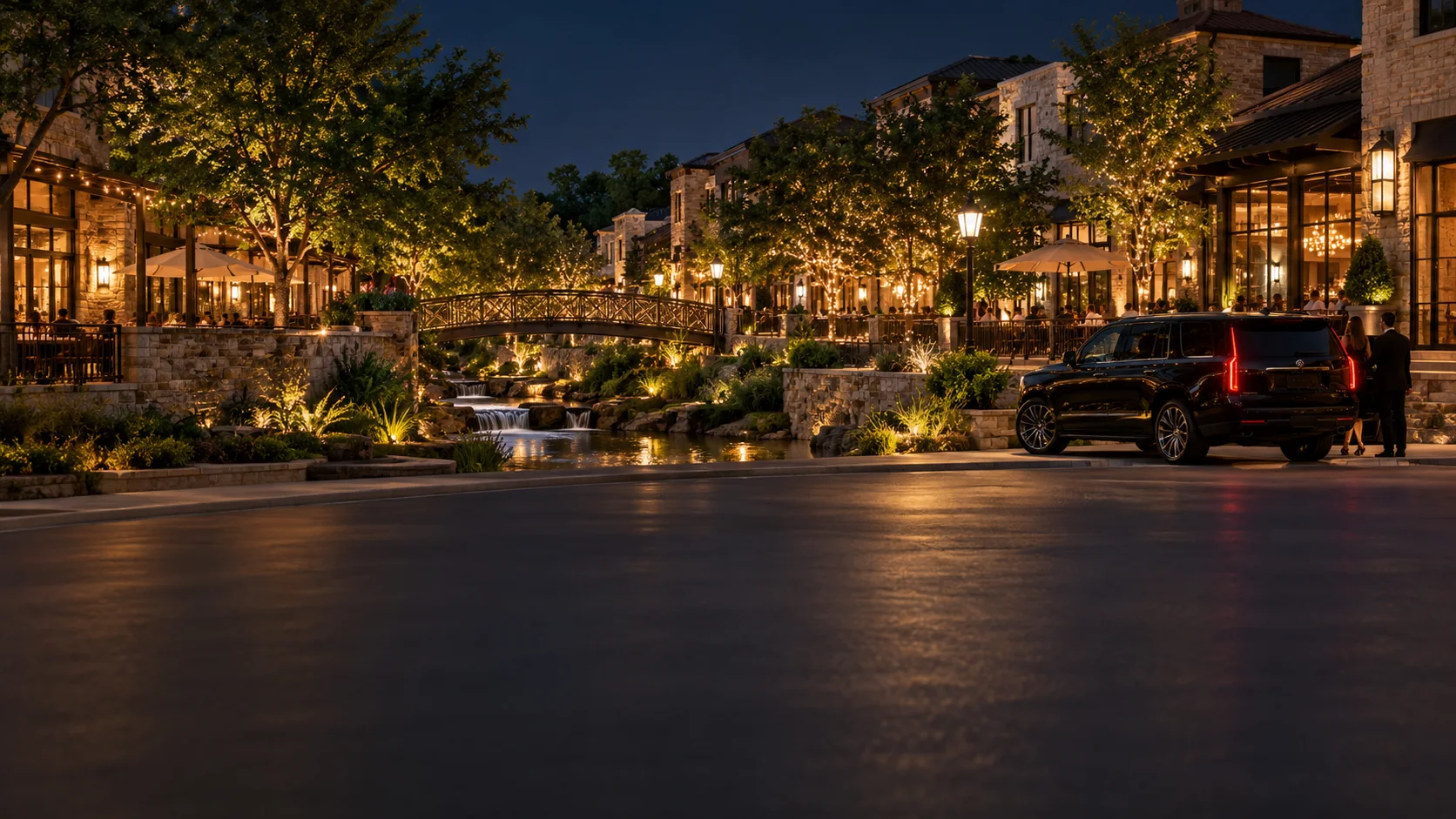 Black SUV black car service at an illuminated open-air plaza in Allen, Texas at night
