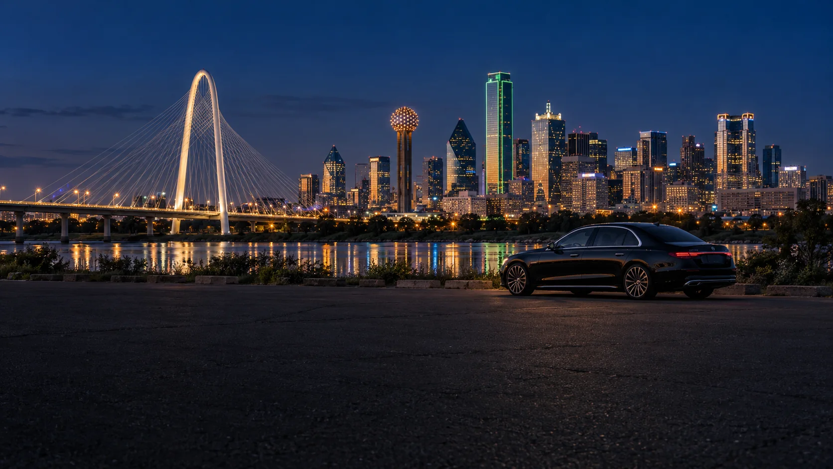 Chauffeured black sedan in front of the Dallas skyline and Margaret Hunt Hill Bridge at night
