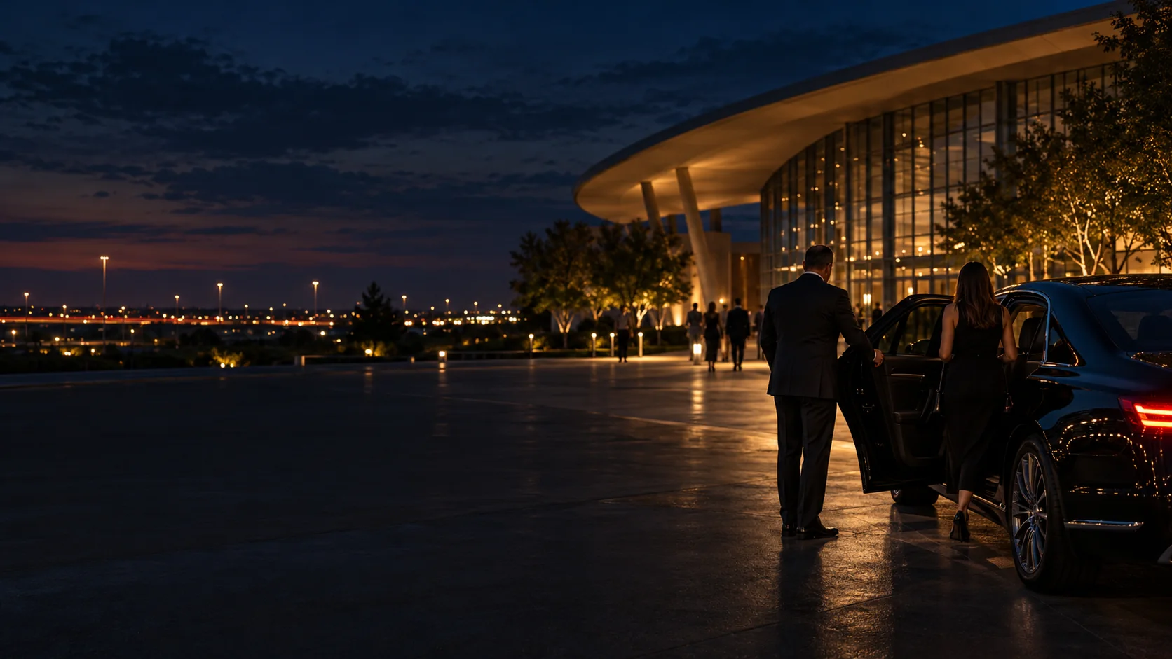 Chauffeur meeting clients at a black car beside a lit venue in Grand Prairie, Texas