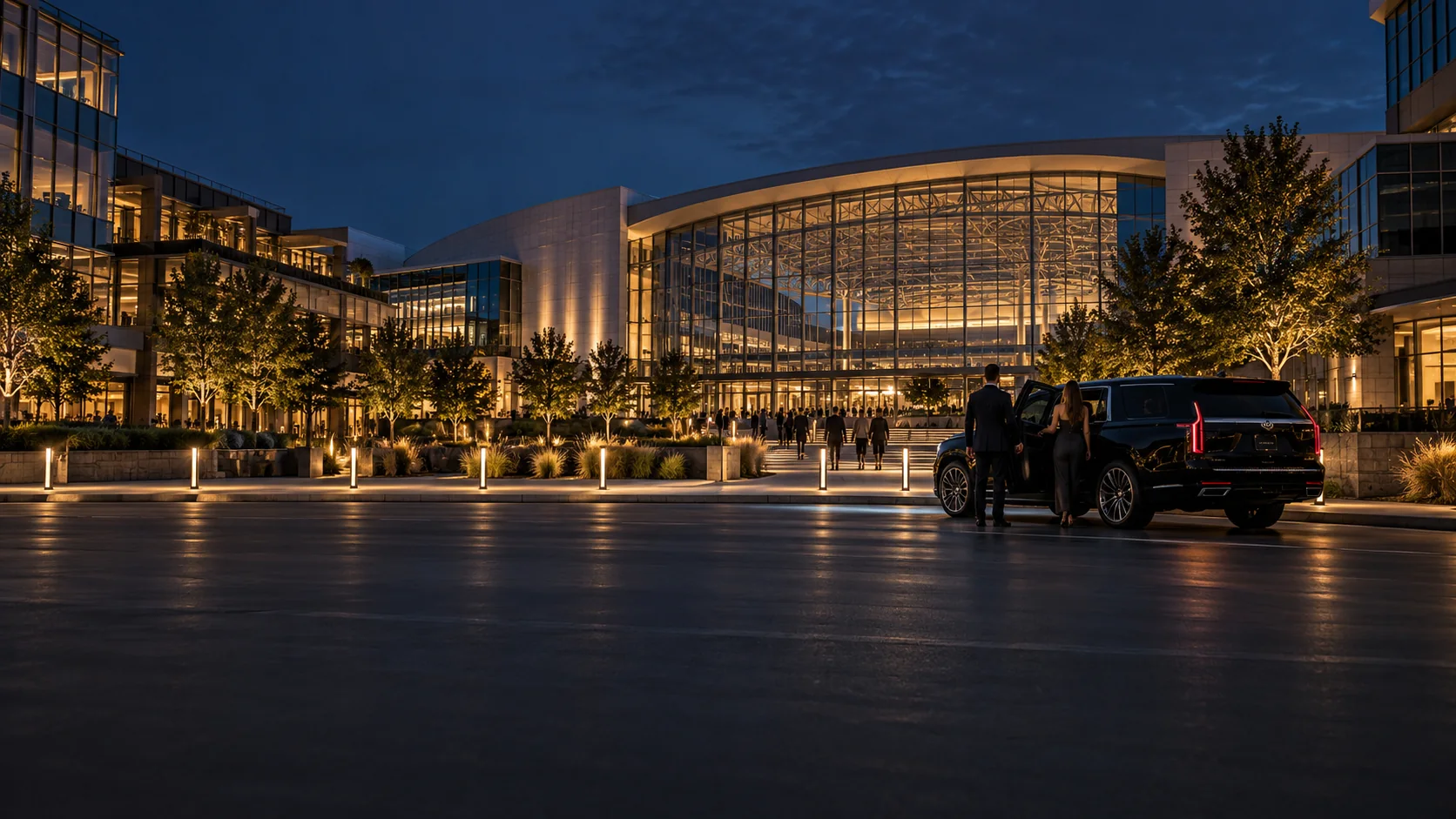 Black SUV chauffeur service outside a glass office campus in Frisco, Texas at night