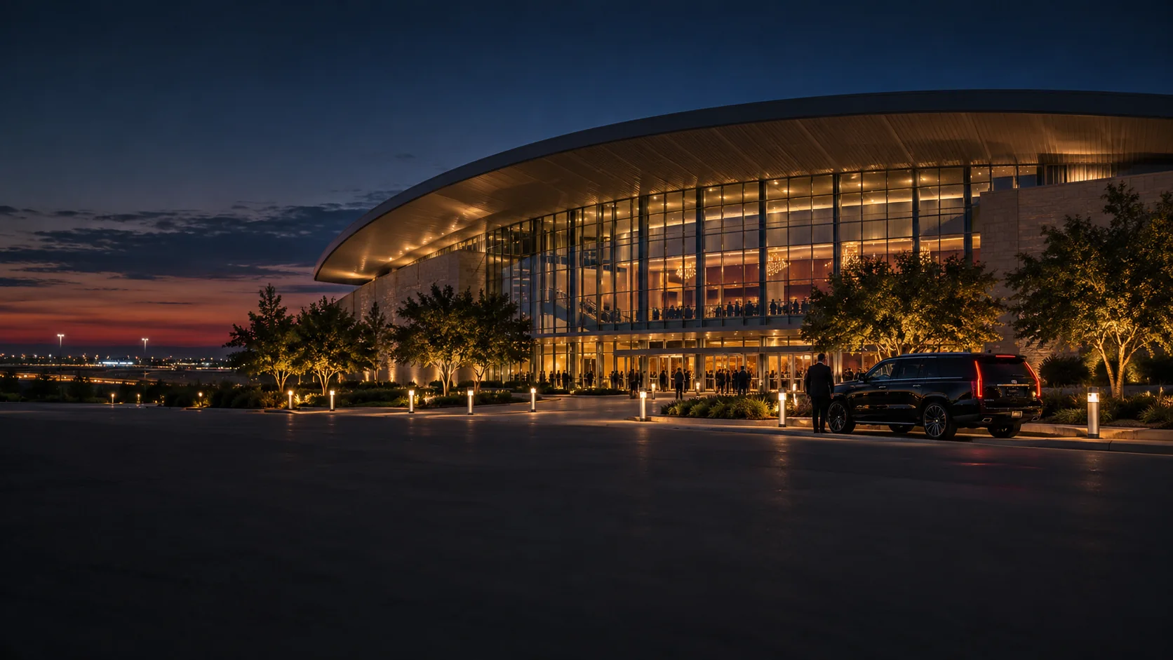 Black SUV car service outside an illuminated entertainment venue in Grand Prairie, Texas