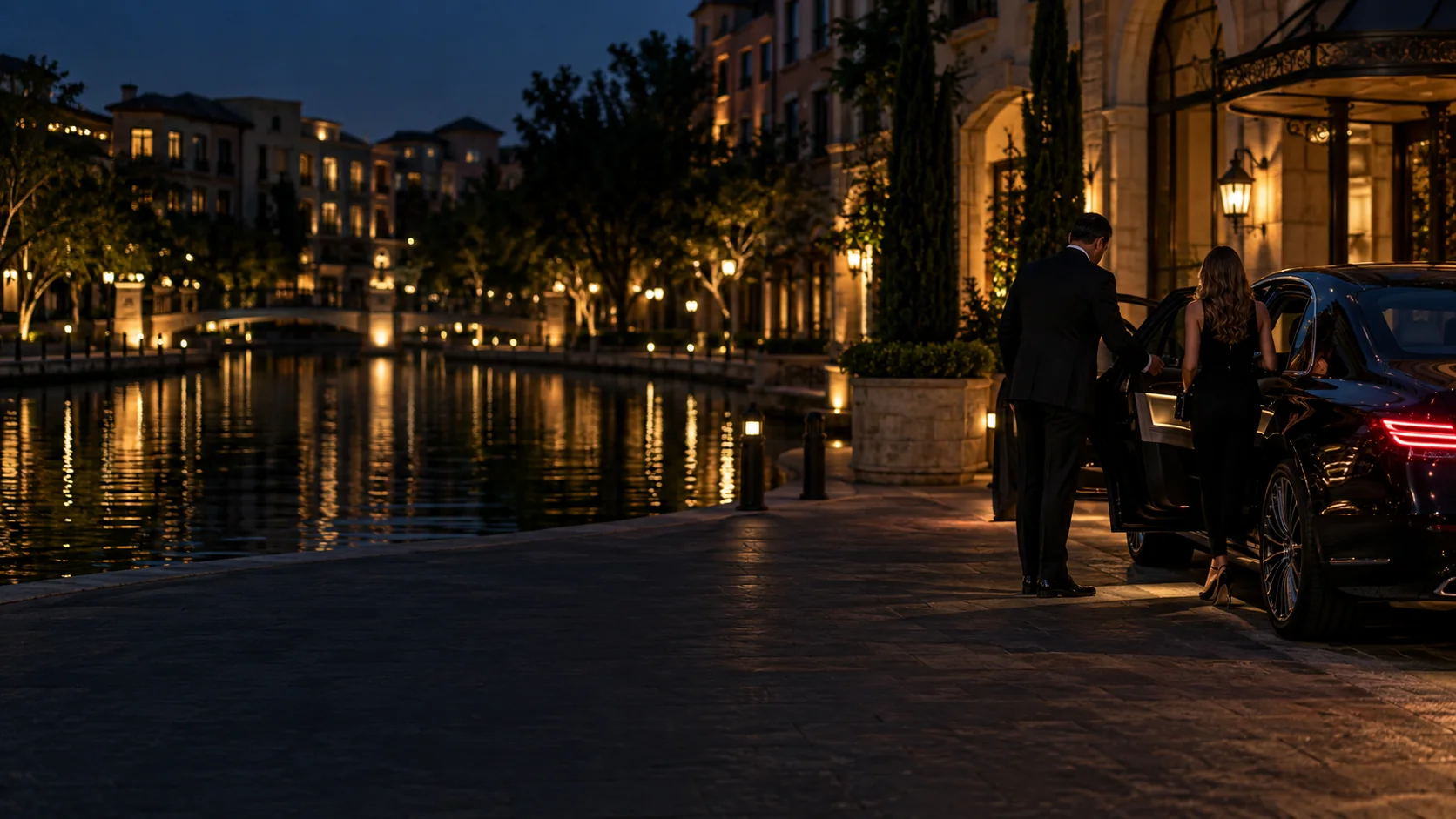 Chauffeur meeting clients beside the Mandalay Canal in Las Colinas, Irving at night