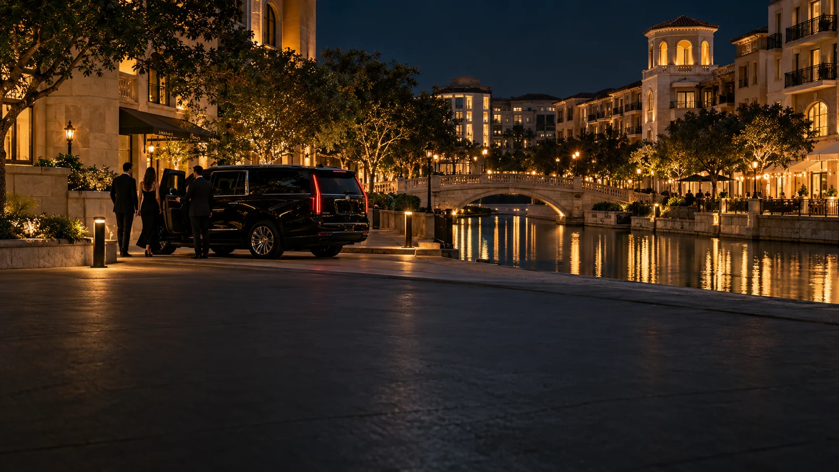 Black SUV chauffeur service by the Mandalay Canal in Las Colinas, Texas at night
