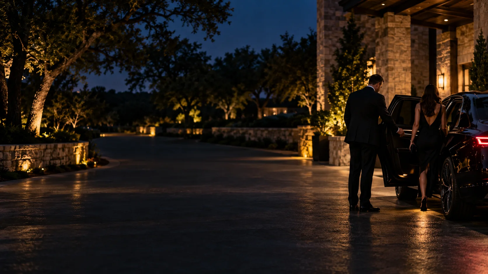Chauffeur opening a car door for clients outside a stone building in Westlake, Texas