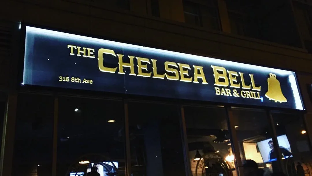 Illuminated storefront sign for The Chelsea Bell Bar & Grill at 316 8th Ave