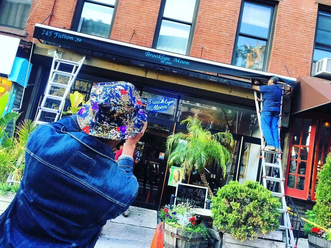 Storefront awning installation in progress at Brooklyn Moon on Fulton Street