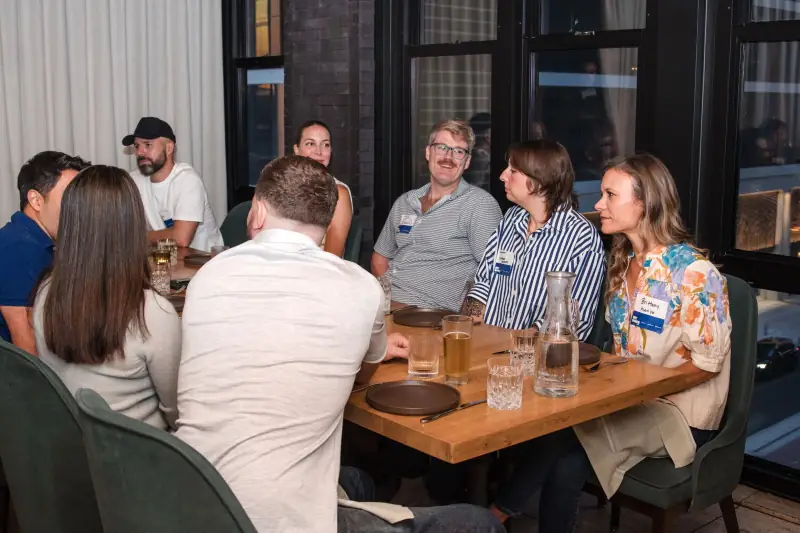 Founders in conversation by the window