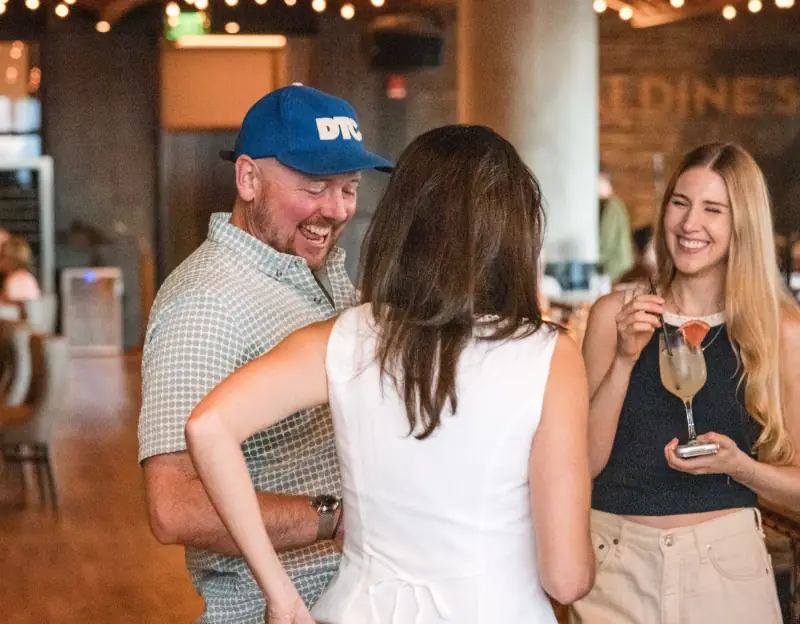 Eric Dyck laughing with guests before dinner